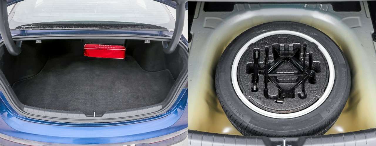 Даже по меркам седанов проем багажника Kia очень узкий. Под полом органайзеров нет, зато колесо полноразмерное, на литом диске.